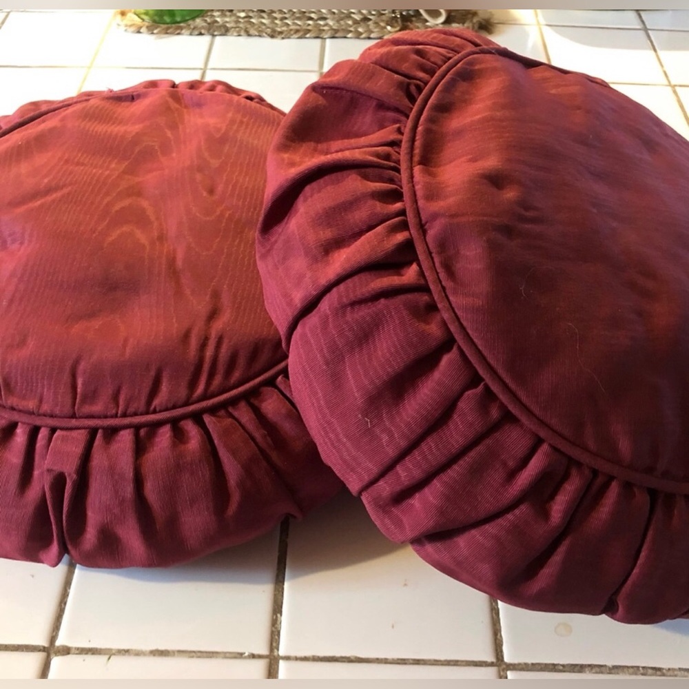 Round pillow set in satiny deep red/ burgundy